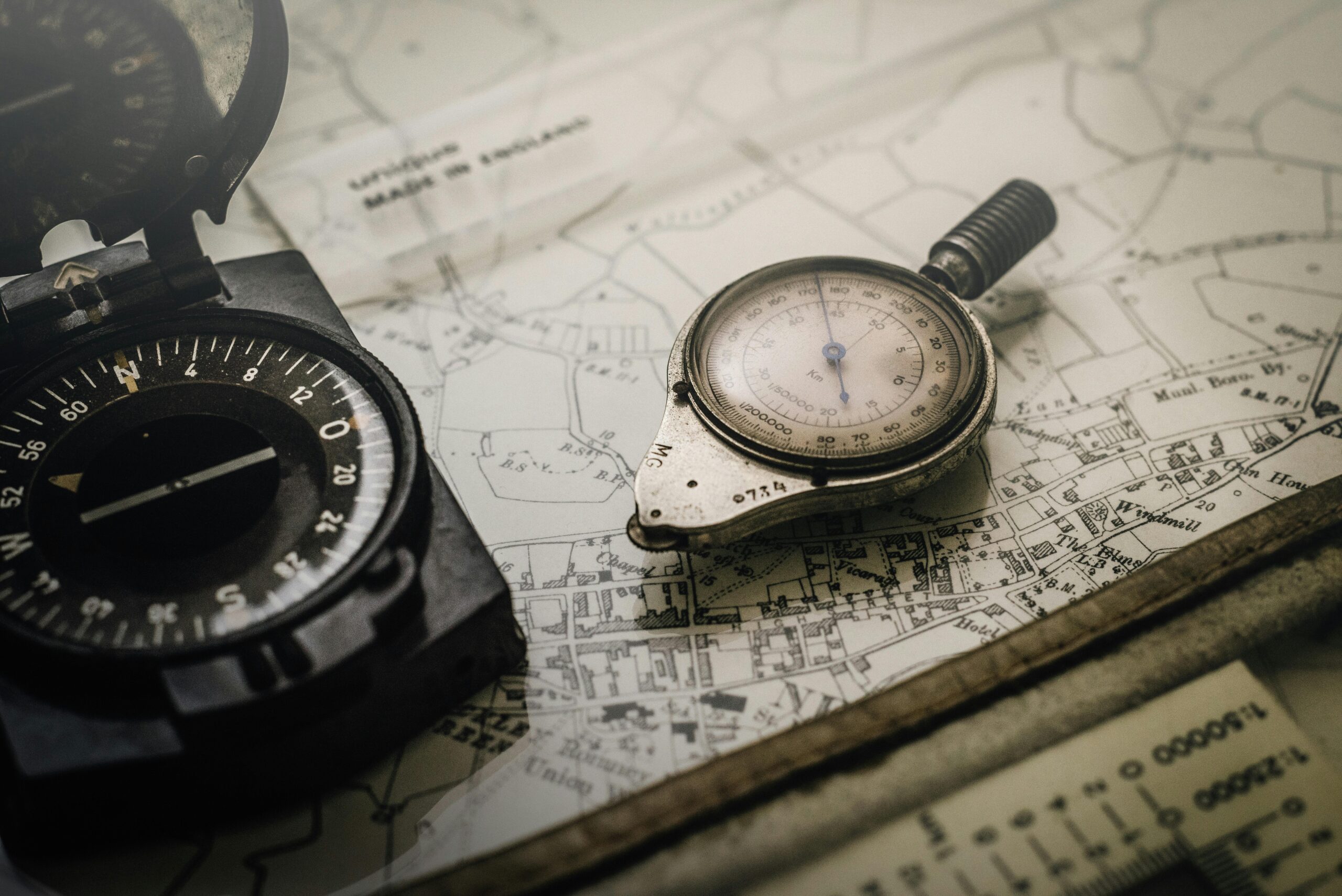 Home A vintage compass and navigation instrument on an old map, showcasing precision tools for exploration.